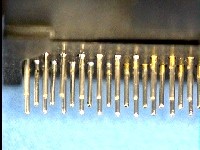Connector pins free of conformal coating on solderable contact area.