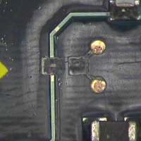 Figure 2: A milling machine and .025" end mill was used to cut out the section of the conductor where the new pad on the left would be added and to spot face down to the ground plane at the two circular locations shown to the right.